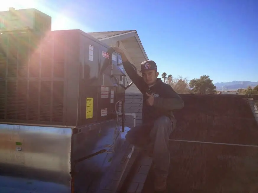 HVAC technician performing HVAC Inspection on a rooftop unit in Beavercreek
